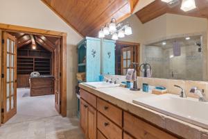 a bathroom with two sinks and a large mirror at Lake View Escape in Whitefish +37 photos