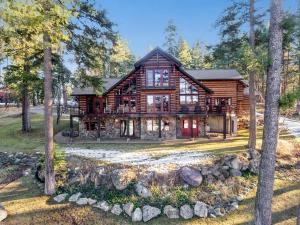 a log home in the woods with trees at Lake View Escape in Whitefish
