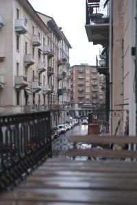 a bench on a city street with parked cars at Bed & Breakfast Sweet life La spezia Liguria in La Spezia