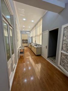 a large kitchen with wooden floors and windows at Vintage Boutique Hostel in Baku