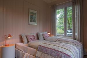 a bedroom with a bed and a window at Kollen Slottet in Oslo