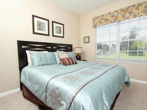 a bedroom with a large bed and a window at Comrow Villa 7739 in Orlando