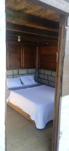 a bedroom with two beds with wooden walls at montecristo hostel in Santa Marta