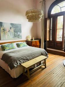 a bedroom with a bed and a wooden floor at Casa Viva Hotel Boutique in Junín