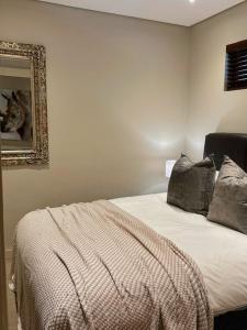 a bed in a room with a mirror and a bed sidx sidx sidx at Resort Retreat, Private Suite, Zimbali Estate in Ballito