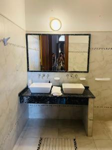 a person taking a picture of a bathroom with two sinks at Casa Viva Hotel Boutique in Junín