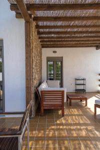 a room with a bed and a bench on a patio at Apollonas & Sibylla Villa in Kalymnos