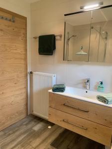 a bathroom with a sink and a mirror at Haus Füsslmühle in Fuschl am See