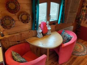 a dining room with a table and two chairs at La roulotte de Mouni in Gesves +31 photos