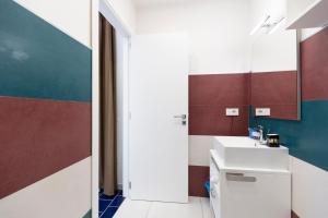a bathroom with a sink and a mirror at Anreale Rooms Paestum in Paestum +111 photos