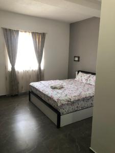 a bedroom with a bed and a window at Hotel Albatros in Prizren