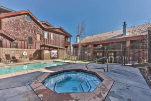 a house with a swimming pool in front of a house at Luxury Condo Steps to Park City Mountain Resort! Heated Pool & Hot Tub -Snowblaze 309 in Park City