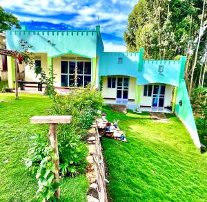una casa con techo azul en un patio en Roots cottages and campsite Ntanda crater lake, 