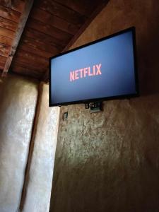a television on a wall with the netflix sign on it at Homatino Eco Smart in Nea Moudania
