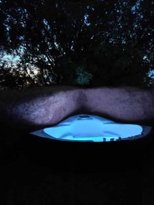 a night view of a blue tub in a field at Homatino Eco Smart in Nea Moudania