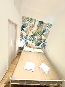 a bed in a room with a mural on the wall at Bari annette room in Bari