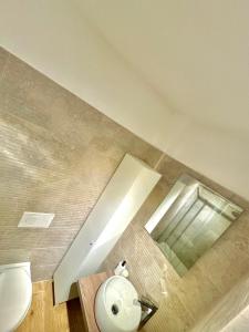 a bathroom with a toilet and a mirror at Bari annette room in Bari +15 photos