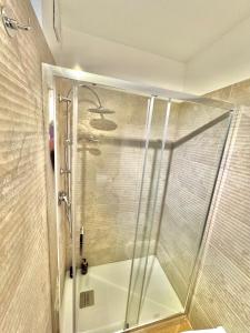 a shower with a glass door in a bathroom at Bari annette room in Bari