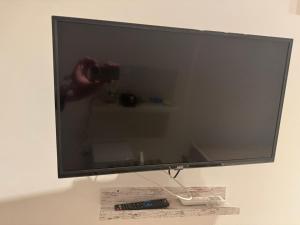 a television screen with a person taking a picture at Bari annette room in Bari