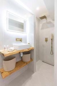 a white bathroom with a sink and a shower at Studio à 200m de la plage de Tahiti beach et à proximité du centre de St Tropez in Saint-Tropez