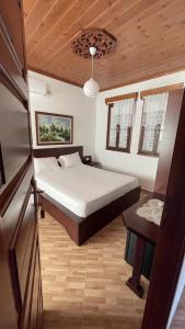 a small bedroom with a bed and a table at Denis House - Private Rooms -Guest House-Hotel-Gjirokastra in Gjirokastër