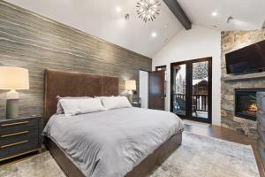a bedroom with a large bed and a fireplace at Slopeside 129 in Whitefish