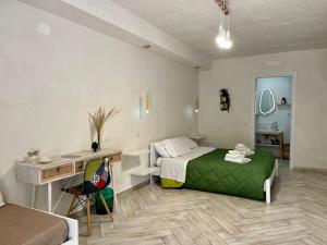 a bedroom with a bed and a desk in it at B&B Kamalei in Tropea