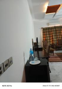 a room with a bottle of water on a table at Palladium Executive in Islamabad