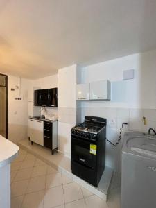 a kitchen with a stove and a sink at Apartamento 202 in Itagüí