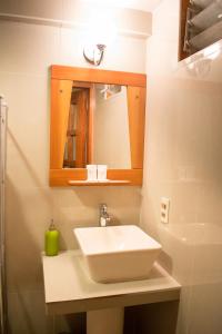 a bathroom with a white sink and a mirror at HOTEL PACHAKUTEQ in Machu Picchu