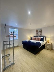 a bedroom with a bed and a treadmill in it at Cosy House Accommodation in Cheltenham
