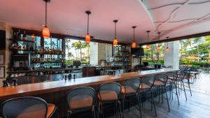 a bar with chairs at a restaurant with pink ceilings at HAWAII-OAHU - Marriott Ko Olina Beach Club Resort in Kapolei