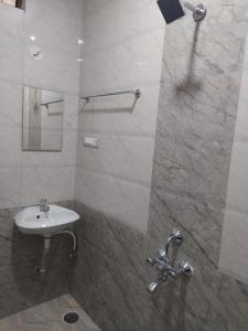 a bathroom with a sink and a shower at Shivaganga Comforts in Bengaluru