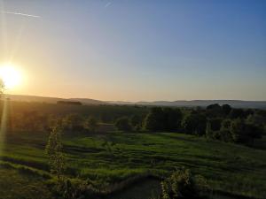 a field with the sun setting in the background at Glühwürmchen in Hameln