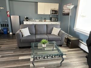 a living room with a couch and a glass table at Middleton Motel & Suites in Middleton