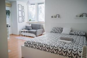 a bedroom with a large bed and a couch at kutak in Sesvete