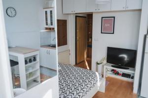 two pictures of a living room with a tv at kutak in Sesvete