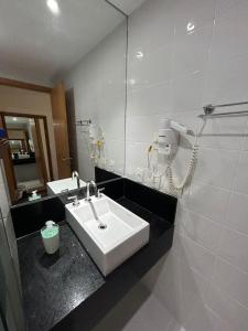 a bathroom with a sink and a mirror at Apto 303- Flat Paraíso in Sao Paulo +21 photos