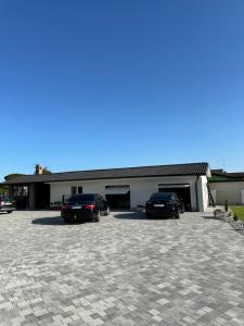 two cars parked in a parking lot in front of a building at Damiani B&B in Muzzana del Turgnano +6 photos