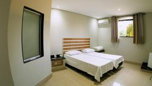 Uma cama ou camas num quarto em SP Jundiaí Hotel