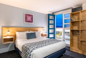 a hotel room with a bed and a balcony at Hotel Camino de la Sal in Zipaquirá +87 photos