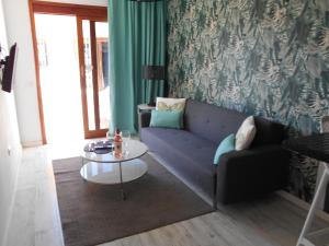 a living room with a couch and a table at Beach Boys Resort Men Only solo hombres in Maspalomas
