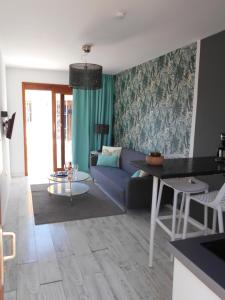 a living room with a couch and a table at Beach Boys Resort Men Only solo hombres in Maspalomas