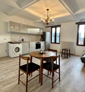 a kitchen and living room with a table and chairs at Stay in Artist’s Gallery in Antwerp