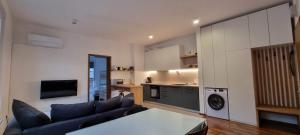 a living room with a couch and a kitchen at Apartma Valan in Bovec