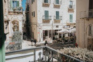 a group of people walking down a city street at Blu Marina Apartment in Giovinazzo
