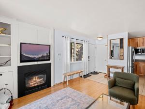 a living room with a fireplace and a tv at Red Pine Condominiums in Park City