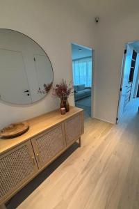 a room with a large mirror on top of a dresser at Enjoy the Belgian coast with indoor heated swimmingpool and fitness in Ostend