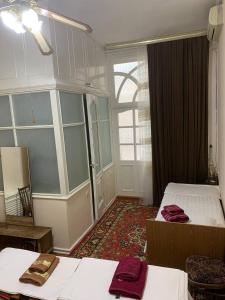 a hotel room with two beds and a window at Timur The Great in Samarkand
