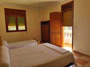 a bedroom with two beds and an open door at Villa in Al hoceima in Al Hoceïma
